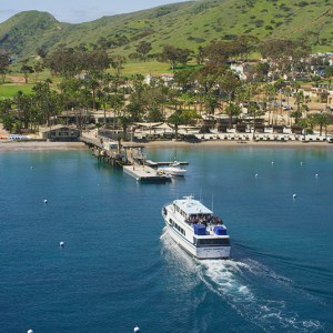 a small boat in a body of water with a city in the background