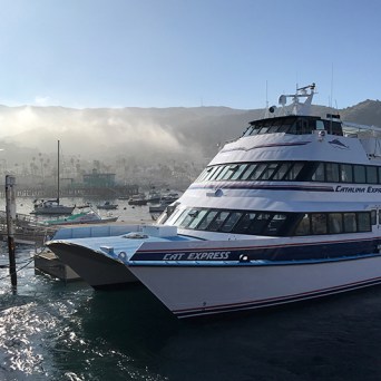 a boat is docked next to a body of water