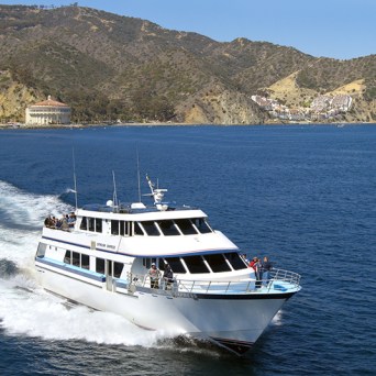 a small boat in a body of water with a mountain in the background