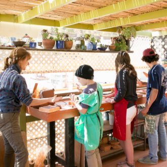 a group of people standing in a kitchen