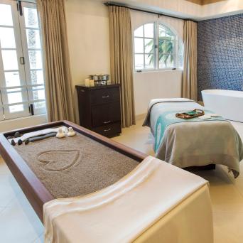 a bedroom with a bed and a chair in a room