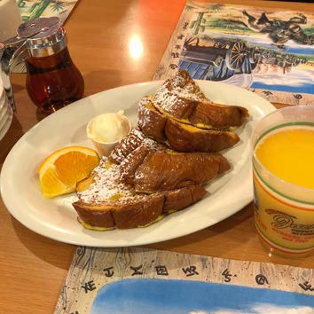 a plate of food sitting on top of a wooden table