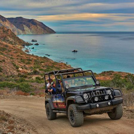 a truck is parked in front of a body of water