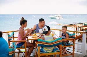 A family enjoying a meal at Descanso Beach Club.