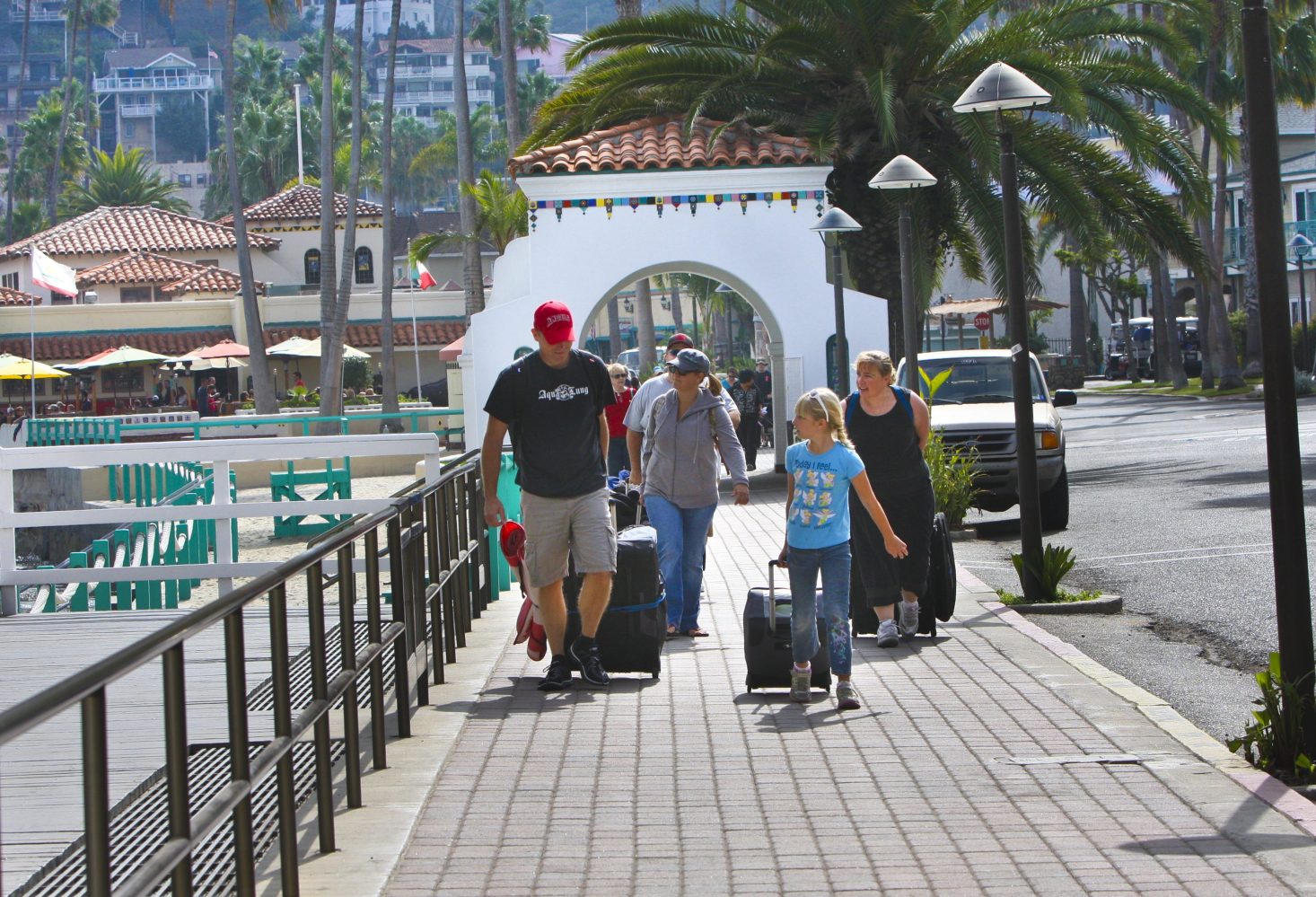 a group of people walking on a sidewalk