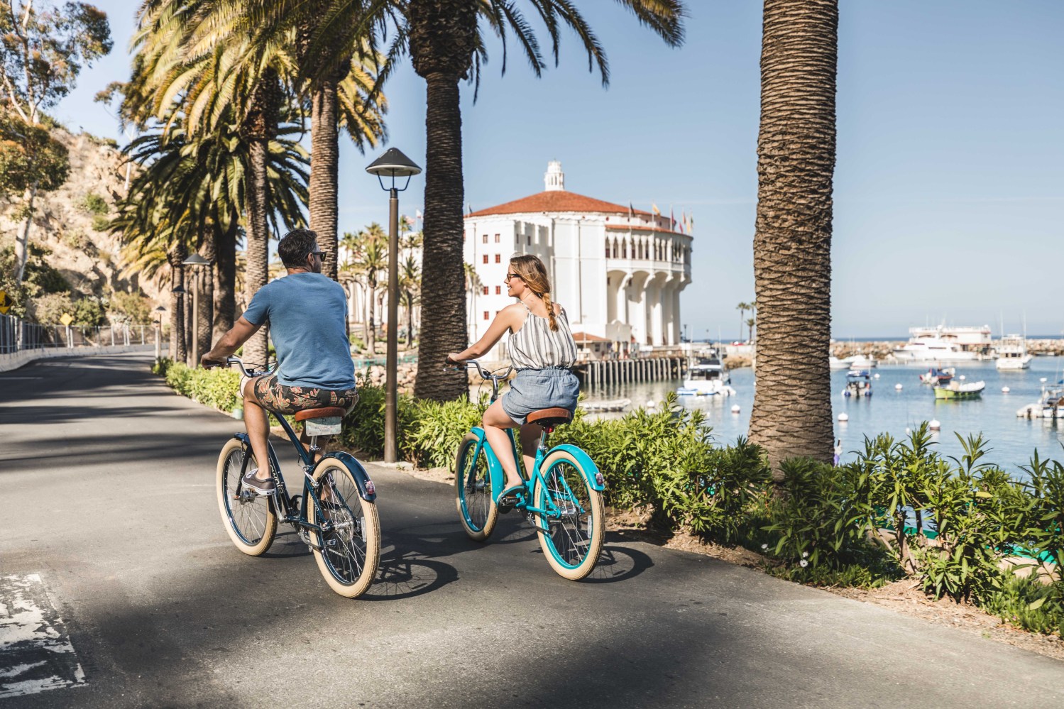 Two people riding bikes around Avalon on Catalina Island.