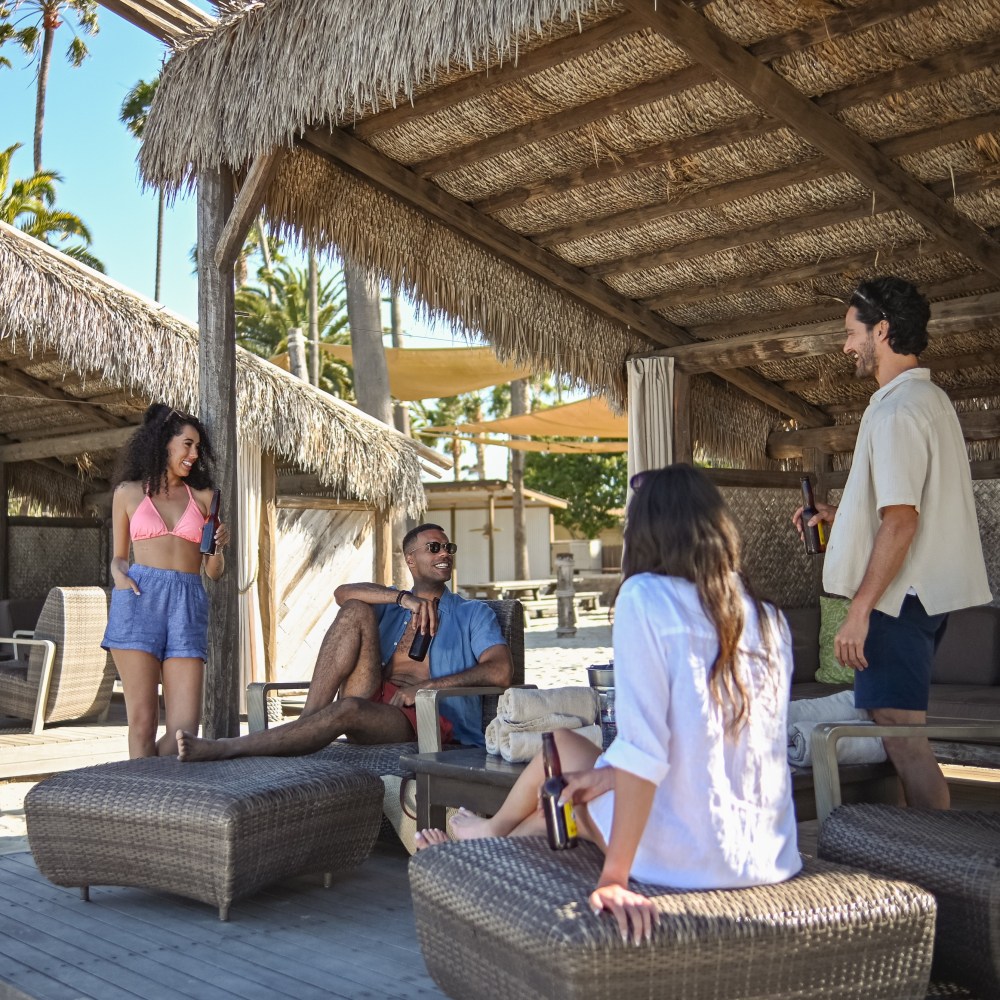 a group of people sitting and standing in front of a building