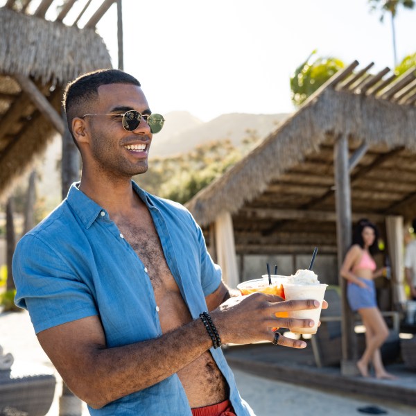 A man holding a drink at Harbor Sands in Two Harbors.