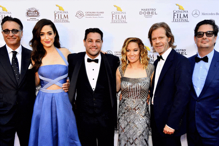 Group of six people in formal attire at a film festival event.